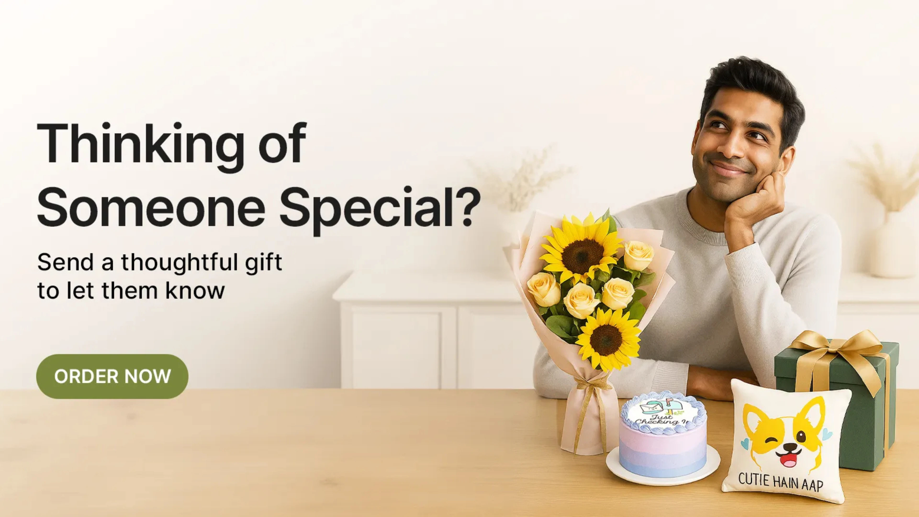 Thoughtful gifts for someone special including sunflowers, a mini cake, and a cute puppy cushion.